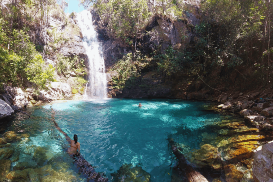 Santa Bárbara Waterfall at Kalunga Quilombo, in Chapada dos Veadeiros — a crystal-clear waterfall forming a natural turquoise pool surrounded by Cerrado vegetation.